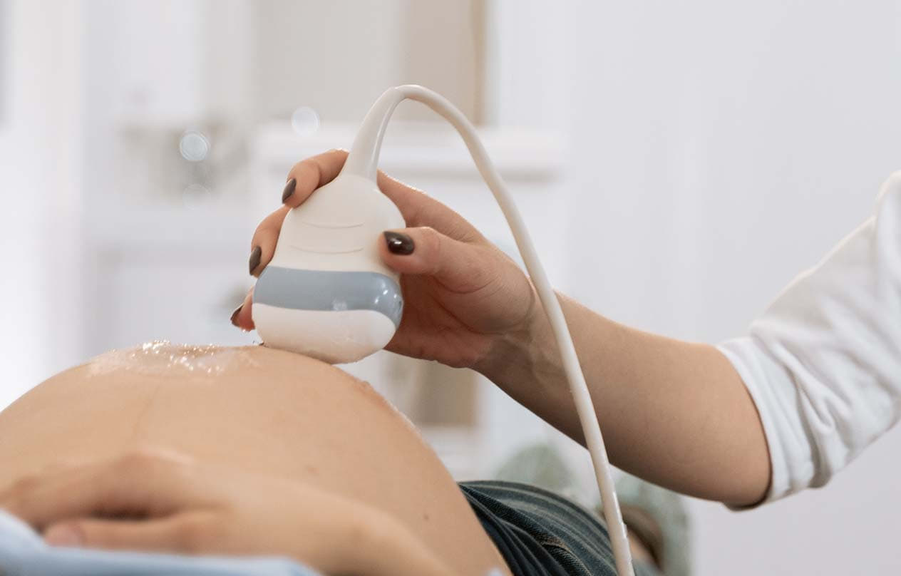 A pregnant woman receiving an ultrasound examination